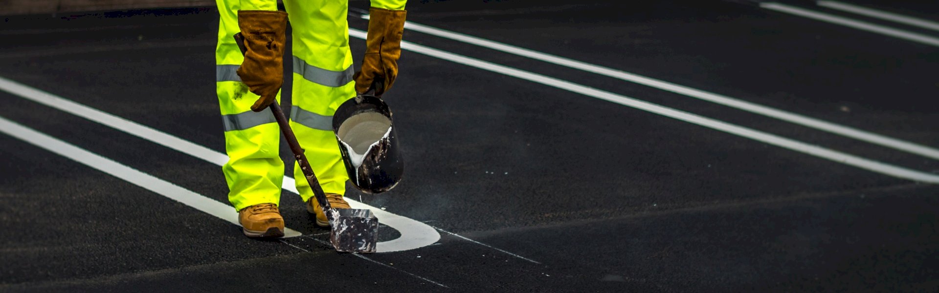 Durable white line marking paint used in a commercial car park with clearly marked parking bays and directional arrows